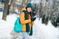 Portrait of attractive cheerful girl wearing warm outfit using device app 5g smm strolling wintertime snowy weather