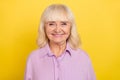 Portrait of attractive cheerful grey-haired granny wearing violet shirt isolated over bright yellow color background Royalty Free Stock Photo