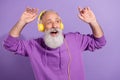 Portrait of attractive cheerful grey-haired man listening bass hit free time dancing isolated over purple violet color Royalty Free Stock Photo