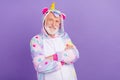 Portrait of attractive cheerful grey-haired man wearing kigurumi folded arms  over violet purple color Royalty Free Stock Photo