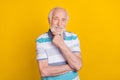 Portrait of attractive cheerful grey haired smart wise man making decision isolated over bright yellow color background