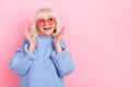 Portrait of attractive cheerful grey-haired woman enjoying new novelty copy space isolated over pink pastel color Royalty Free Stock Photo