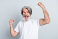 Portrait of attractive cheerful lucky gray-haired man rejoicing having fun isolated over grey pastel color background