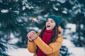 Portrait of attractive cheerful pre-teen girl wearing warm outfit burning bengal fire spark having fun in forest Royalty Free Stock Photo