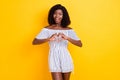 Portrait of attractive cheerful slim glad girl showing heart shape affection 14 February isolated over bright yellow