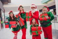 Portrait of attractive cheerful stylish funky group elfs holding giftboxes shopping eve festal time advent spirit at