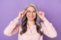 Portrait of attractive cheerful trendy glad clever woman touching eyewear healthy view isolated over violet purple color