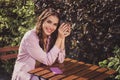 Portrait of attractive cheerful wavy-haired girl resting spending day drinking cappuccino time fresh air outdoors Royalty Free Stock Photo