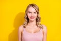 Portrait of attractive cheerful wavy-haired girl wearing tanktop isolated over bright yellow color background Royalty Free Stock Photo