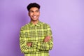 Portrait of attractive cheerful wavy-haired guy wear checked shirt folded arms copy space isolated over violet purple Royalty Free Stock Photo