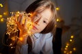Portrait of attractive cheerful young girl resting festal day december winter in room decorated for Christmas. Child in Royalty Free Stock Photo