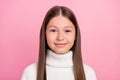 Portrait of attractive cheery content brown-haired preteen girl wearing warm jumper isolated over pink pastel color