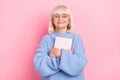 Portrait of attractive cheery dreamy smart grey-haired woman hugging book isolated over pink pastel color background Royalty Free Stock Photo