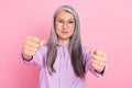 Portrait of attractive cheery focused gray-haired woman driving invisible car isolated over pink pastel color background Royalty Free Stock Photo