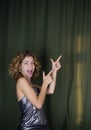Portrait of attractive coquettish funny girl 18 years , hand gesture gives good recommendation Royalty Free Stock Photo