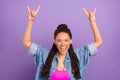Portrait of attractive crazy cheerful girl showing double horn sign good mood isolated over bright purple violet red
