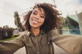 Portrait of attractive curly hairstyle dark skin lady take selfie photo toothy smile good mood free time outdoors