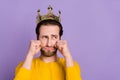 Portrait of attractive desperate sullen man wearing crown crying isolated over pastel violet purple color background Royalty Free Stock Photo