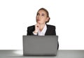 Portrait of attractive dreaming young business woman in formal clothes isolated on white background sitting on desk and working on Royalty Free Stock Photo