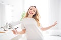 Portrait of attractive dreamy carefree cheerful blond girl drying hair having fun rest at light white home indoors