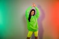 Portrait of attractive dreamy cheerful girl dancing rest relax chill out night isolated over multicolor vivid neon light