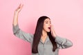 Portrait of attractive dreamy girl awakening stretching yawning over pink pastel color background