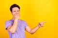 Portrait of attractive dreamy guy showing copy blank space place closing mouth isolated over bright yellow color Royalty Free Stock Photo