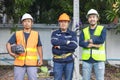 Portrait of an attractive electrician in uniform on a construction site with a power wire for the network, Electrical Engineer at Royalty Free Stock Photo