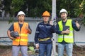 Portrait of an attractive electrician in uniform on a construction site with a power wire for the network, Electrical Engineer at Royalty Free Stock Photo