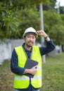 Portrait of an attractive electrician in uniform on a construction site with a power wire for the network, Electrical Engineer at Royalty Free Stock Photo
