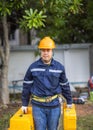 Portrait of an attractive electrician in uniform on a construction site with a power wire for the network, Electrical Engineer at Royalty Free Stock Photo