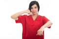 Portrait of attractive female nurse making contact gesture