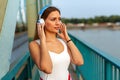 Portrait of attractive fit woman enjoying running, healthy lifestyle ourdoors in urban background.