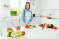 Portrait of attractive focused girl making meal chopping useful vegs weight loss at home light white kitchen indoors Royalty Free Stock Photo