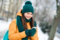 Portrait of attractive focused girl wearing warm outfit using device gadget watching video wintertime snowy weather