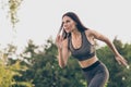 Portrait of attractive focused purposeful girl doing workout running early morning day shaping pilates outdoor