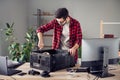 Portrait of attractive focused skilled trendy guy fixing improving motherboard processor at studio office workplace Royalty Free Stock Photo