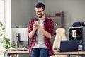 Portrait of attractive focused trendy guy using device gadget browsing web bug report blog at office workplace