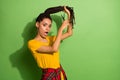 Portrait of attractive funky worried girl cutting curls problem solution  over bright green color background Royalty Free Stock Photo