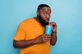 Portrait of attractive funny amazed guy drinking soda free spare time isolated over bright blue color background Royalty Free Stock Photo