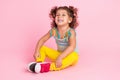 Portrait of attractive funny cheerful wavy-haired girl sitting on floor laughing good mood  over pink pastel Royalty Free Stock Photo