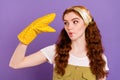 Portrait of attractive funny girl housemaid plating with hand in dotted glove grimacing isolated over violet purple Royalty Free Stock Photo