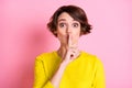 Portrait of attractive funny mysterious brown-haired girl showing shh sign isolated over pink pastel color background Royalty Free Stock Photo