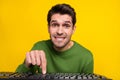 Portrait of attractive funny worried guy nerd pressing button using laptop oops isolated over vibrant yellow color