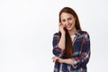 Portrait of attractive ginger girl, smiling and blushing, looking shy at camera, touching soft and clean facial skin Royalty Free Stock Photo