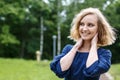 Portrait attractive girl with blond hair in a park Royalty Free Stock Photo