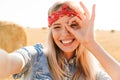 Portrait of attractive girl 20s laughing and taking selfie while Royalty Free Stock Photo