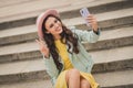 Portrait of attractive girl sit on stair make selfie fingers show v-sign have good mood free time outdoors Royalty Free Stock Photo