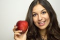 Portrait of attractive girl smiling with red apple in her hand healthy fruit Royalty Free Stock Photo