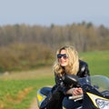 Portrait of a beautiful blonde woman on a sports motorcycle Royalty Free Stock Photo